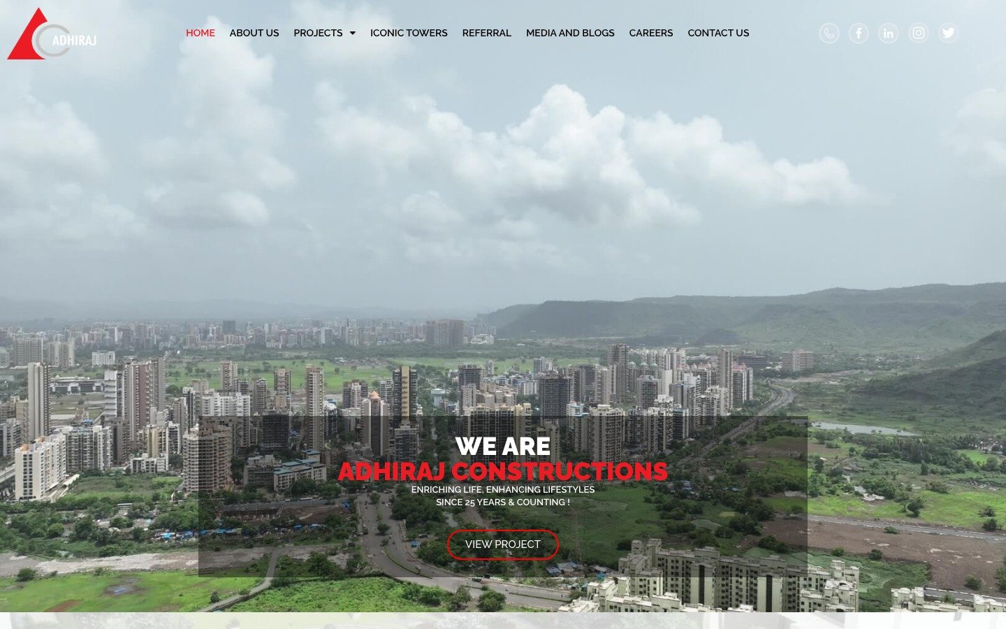 Adhiraj Constructions website on laptop